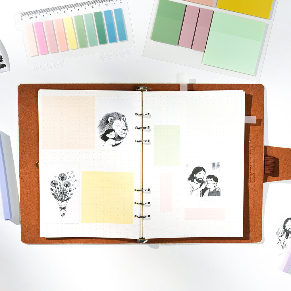 FaithTag Favorites notebook open with pastel sticky notes and Christian-themed stickers, ideal for Bible journaling, devotion, and creative note-taking.